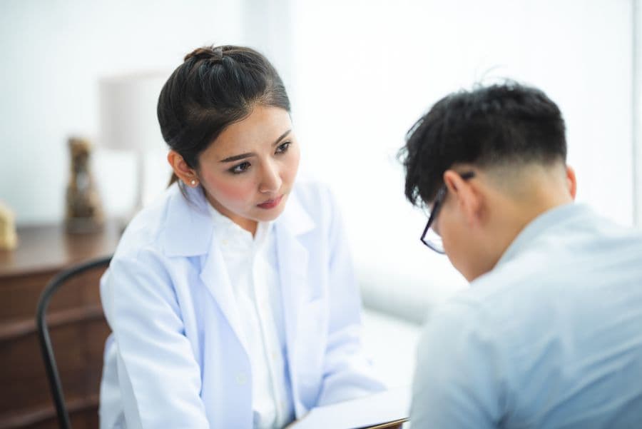 A doctor listening to a patient during a consultation