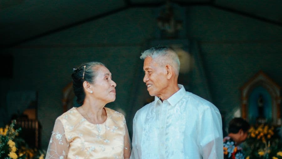 An elderly couple together at a ceremony